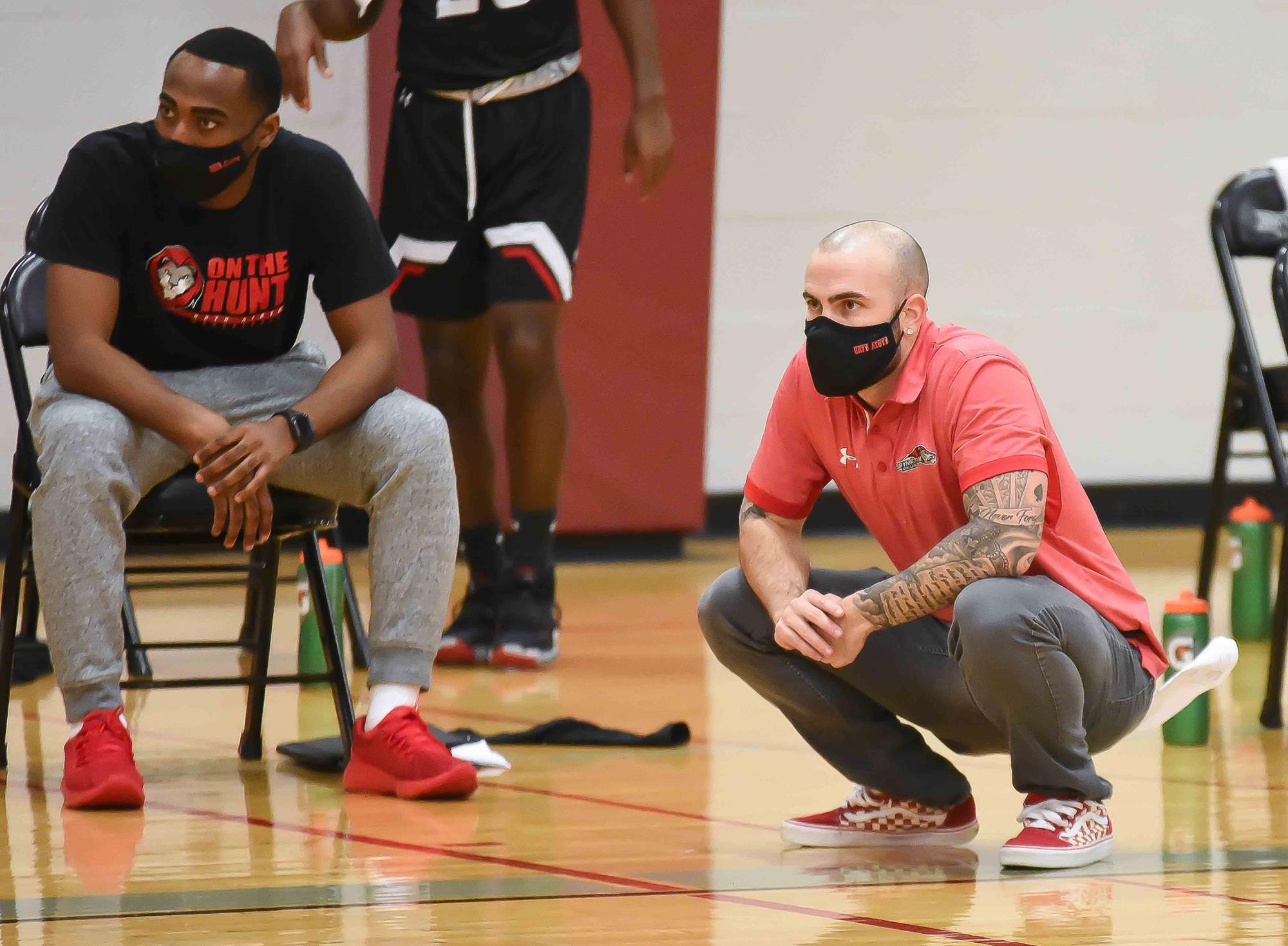 Coach West kneel